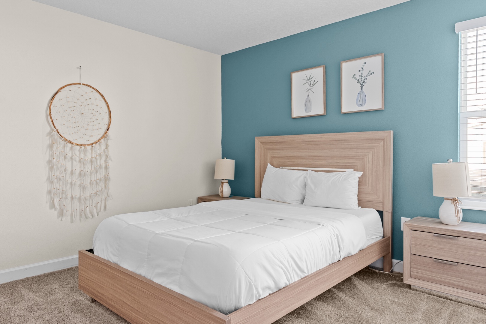Drift off to peaceful dreams in your serene bedroom featuring crisp white linens and calming coastal teal accents.