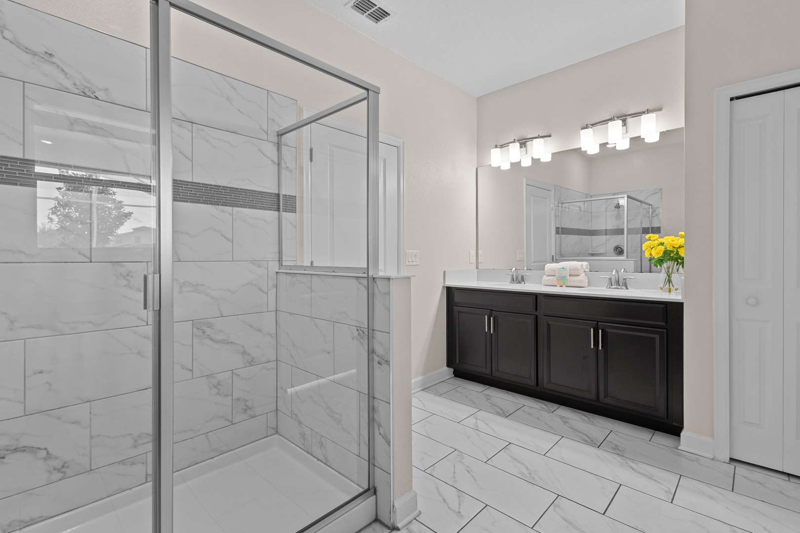 Step into your private spa-like retreat with elegant marble tile, spacious glass shower, and sleek vanity—perfect for unwinding after your adventures.