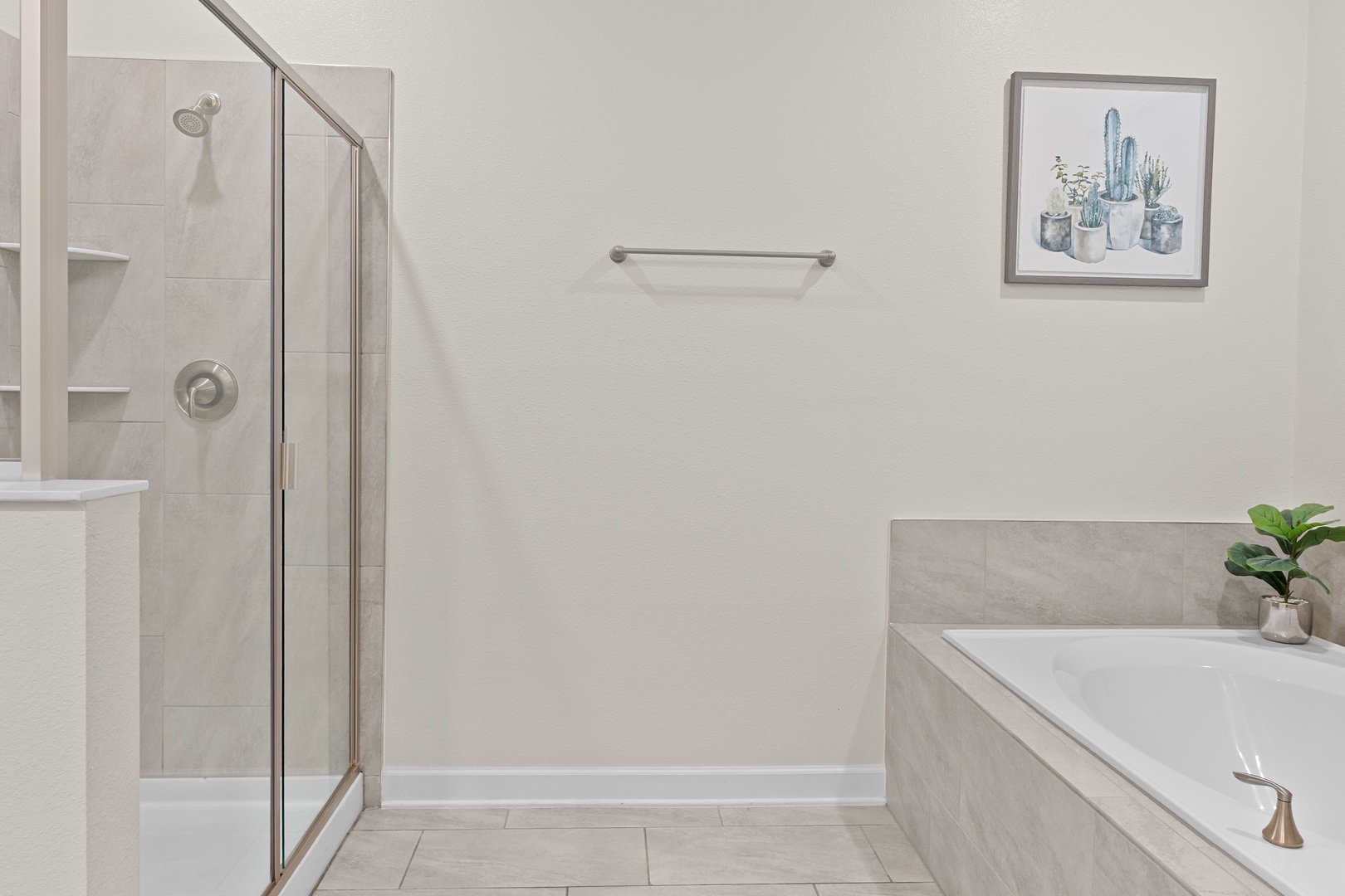 Your private spa-like bathroom features a spacious glass shower and soaking tub for ultimate relaxation after exploring.