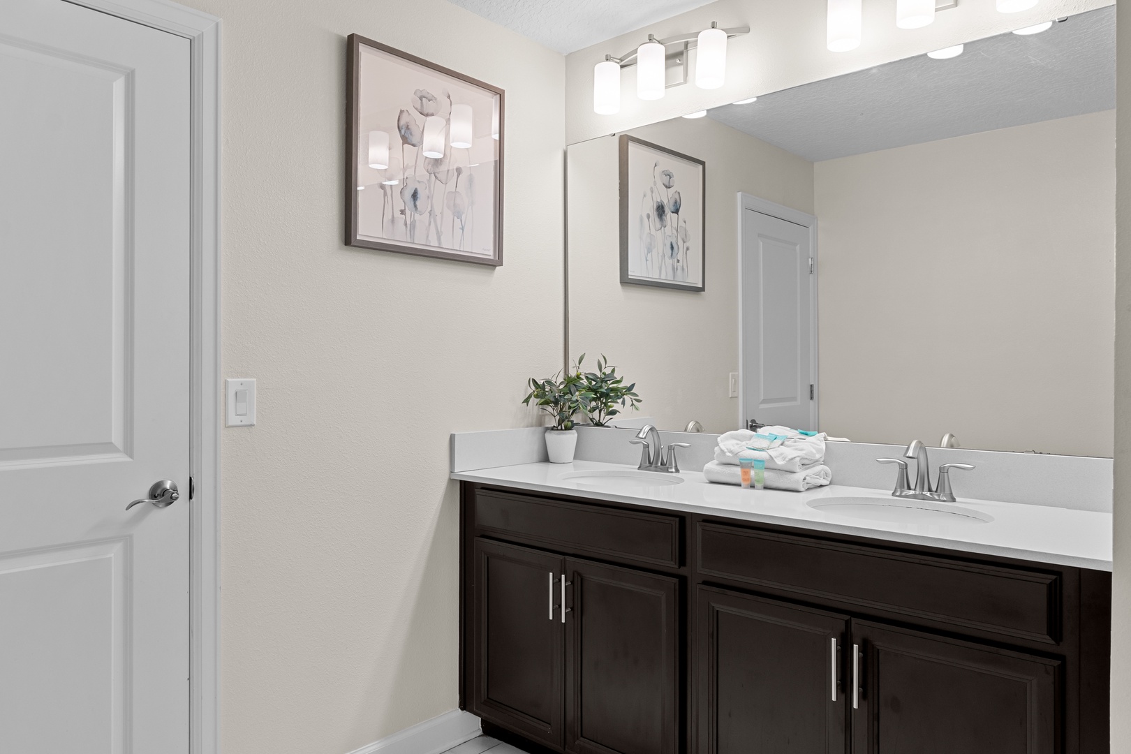 Refresh in this elegant dual-sink vanity with modern fixtures, tasteful artwork, and fluffy towels awaiting your arrival.