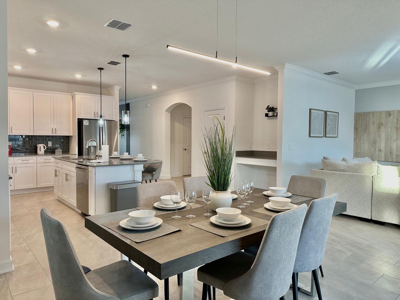 Your open-concept dining and kitchen area creates the perfect space for memorable meals, with modern finishes and thoughtful lighting throughout.