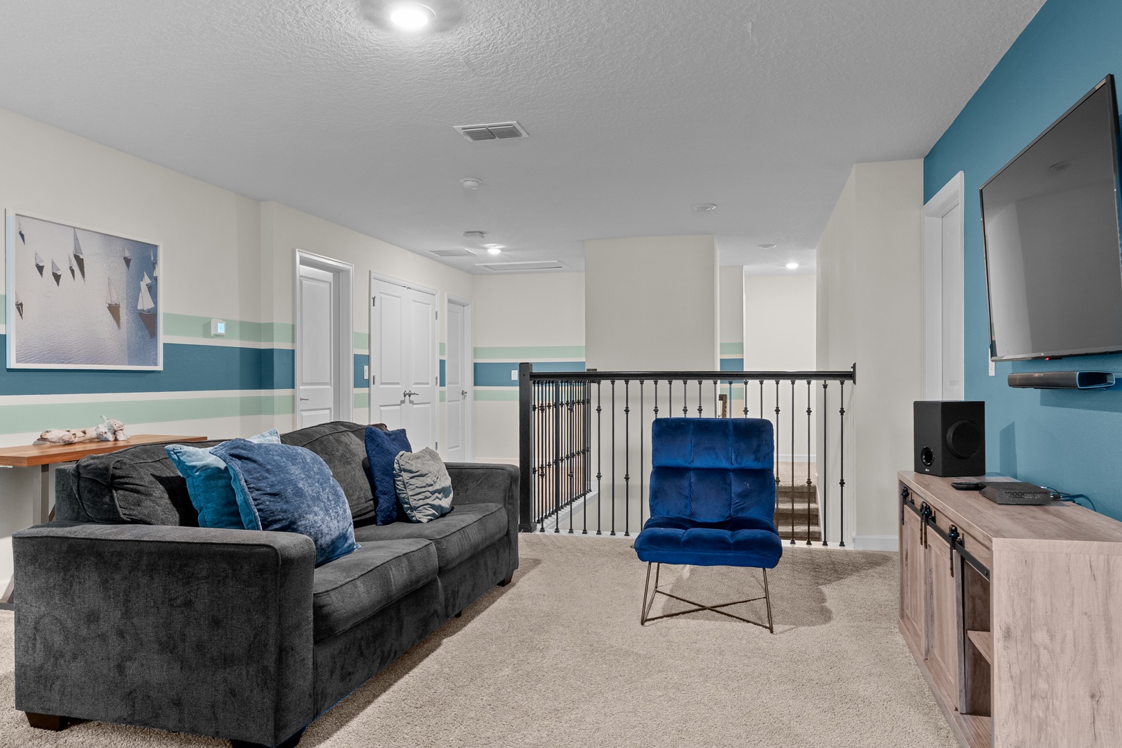 Settle into this stylish upstairs lounge where you can unwind on plush gray seating while enjoying entertainment on the mounted TV.