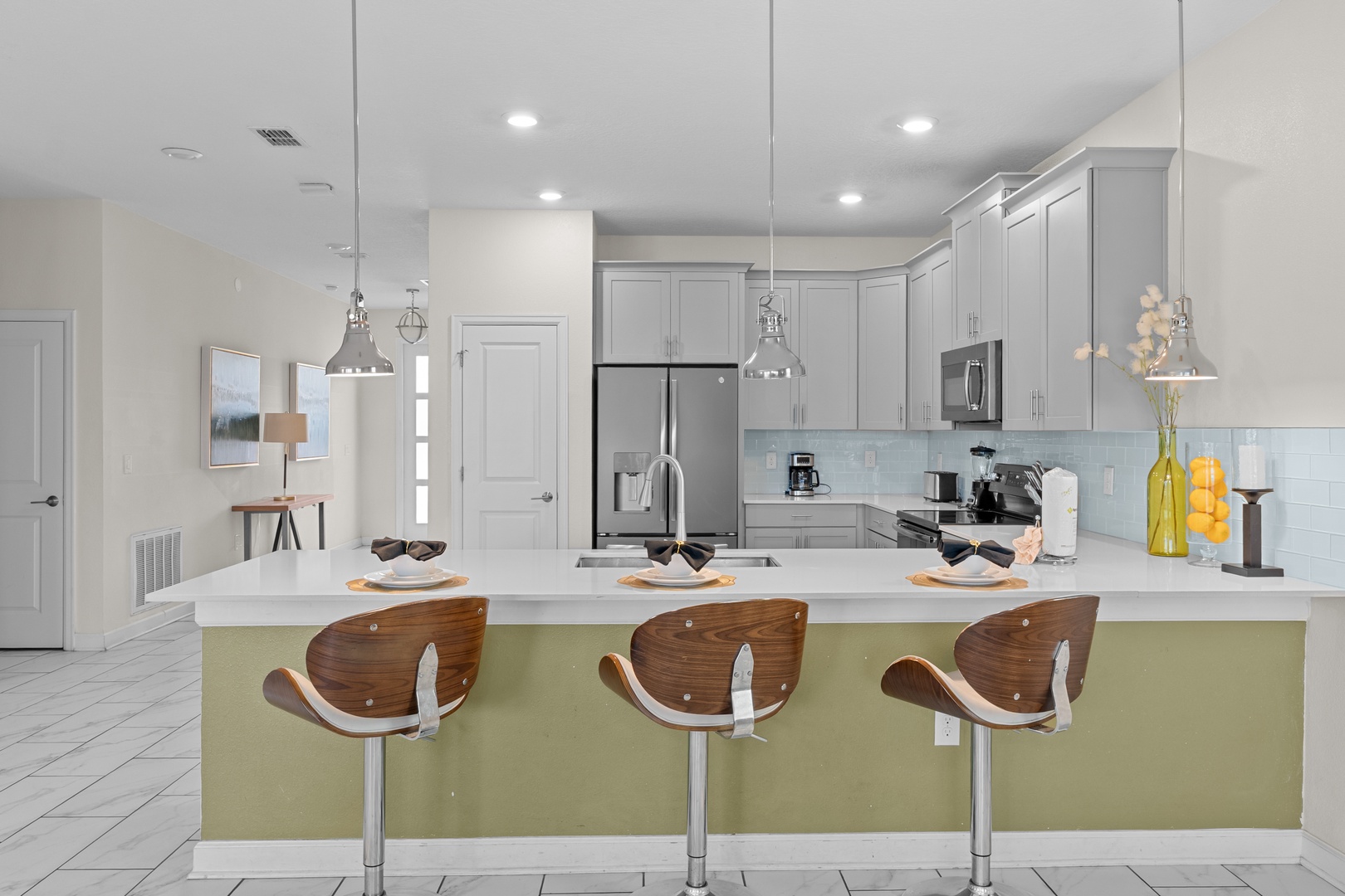 Cook with ease in your modern kitchen featuring stainless steel appliances, granite countertops, and a stylish breakfast bar.