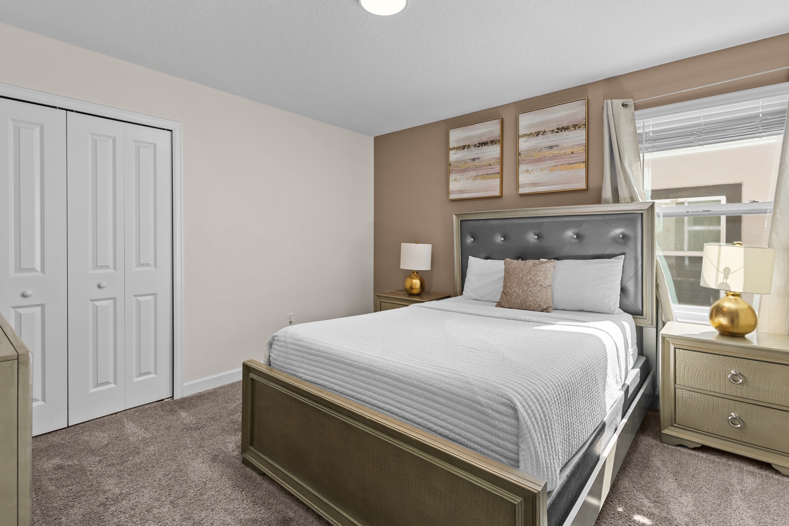 Your elegant bedroom features a plush queen bed, warm lighting, and ample storage. Drift off peacefully in this beautifully appointed space.