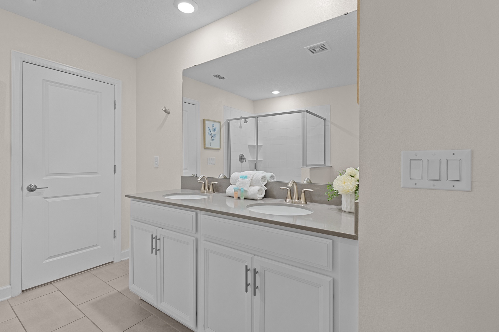 Refresh in your pristine ensuite with dual sinks, spacious vanity, and glass-enclosed shower—fresh towels and amenities await.