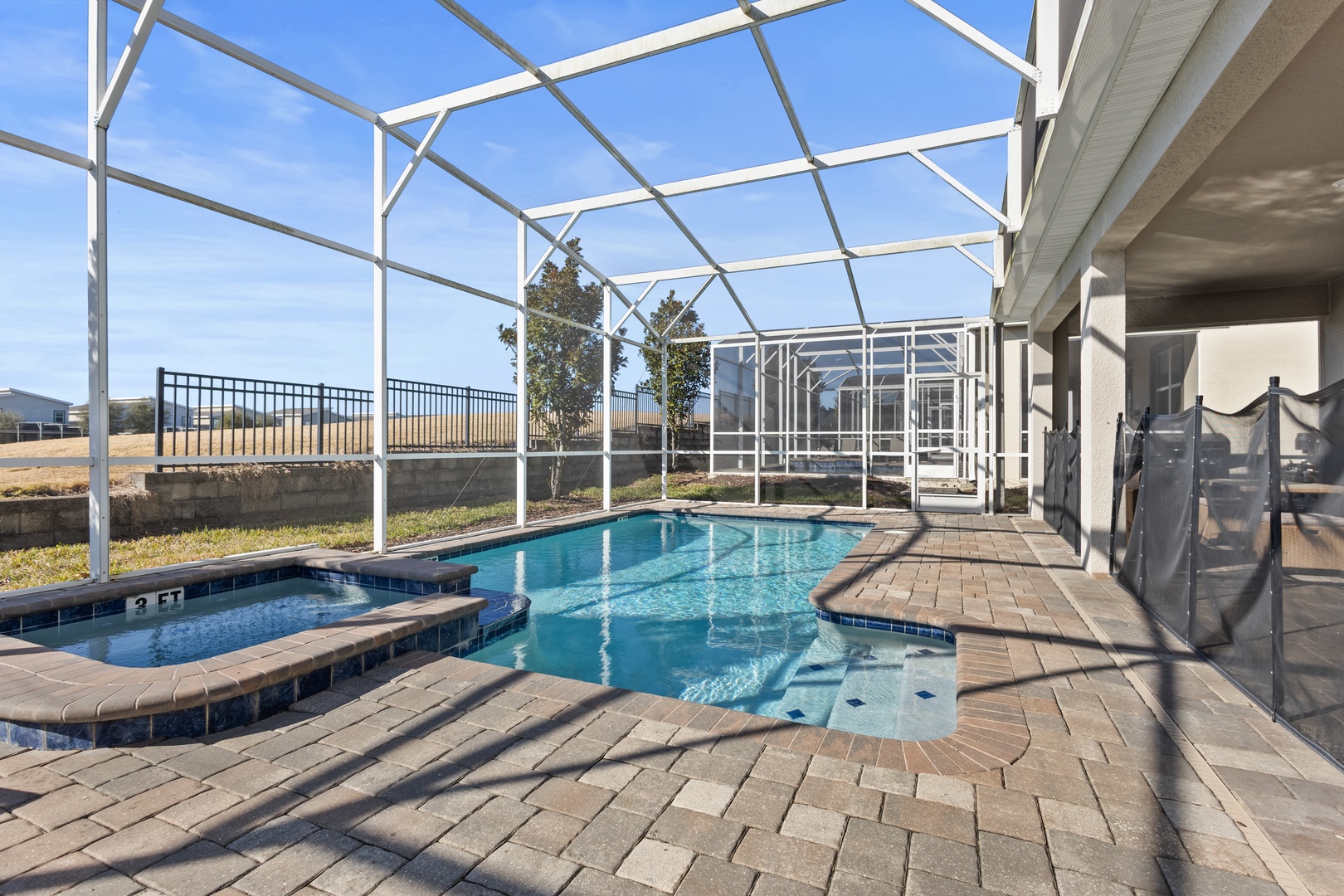 Your private screened pool area offers crystal-clear waters perfect for refreshing dips, while the spacious covered patio provides shade for relaxing poolside moments.