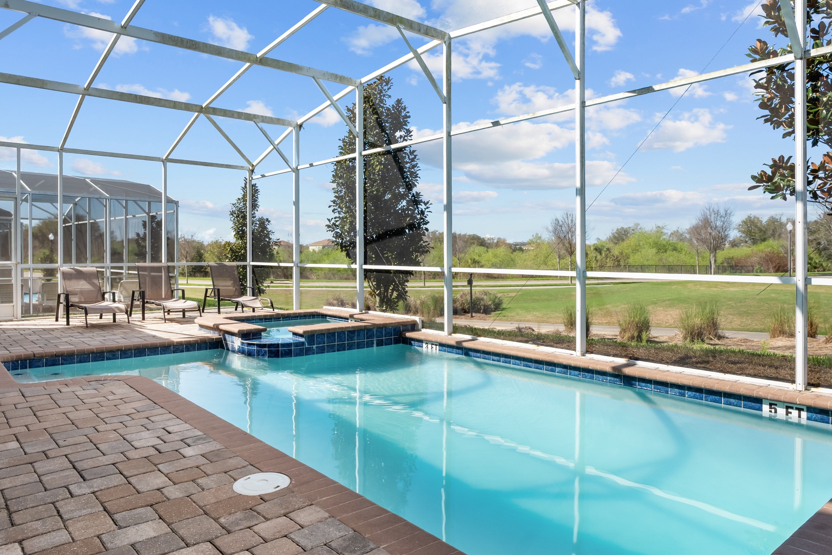 Step into your private pool oasis, where crystal-clear waters and spa sparkle under a protective screen enclosure.