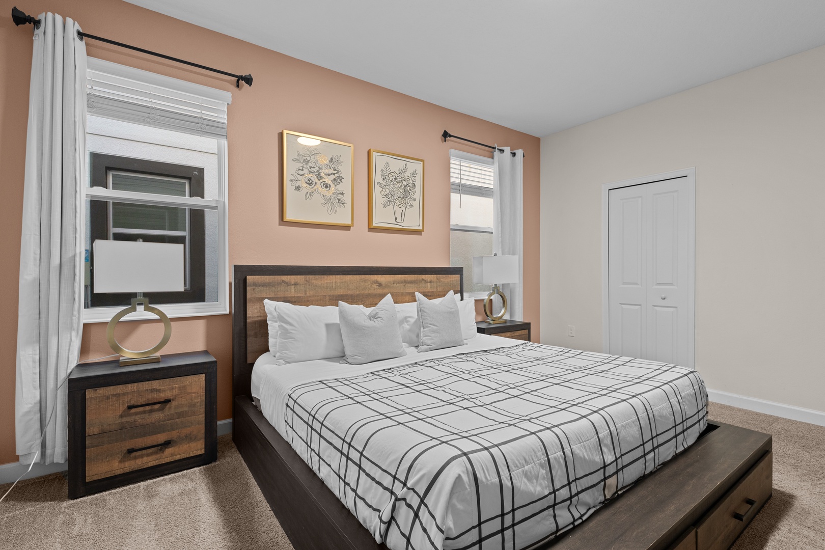 Sink into crisp white linens and wake refreshed in your stylish bedroom, featuring warm wood accents and peaceful decor.