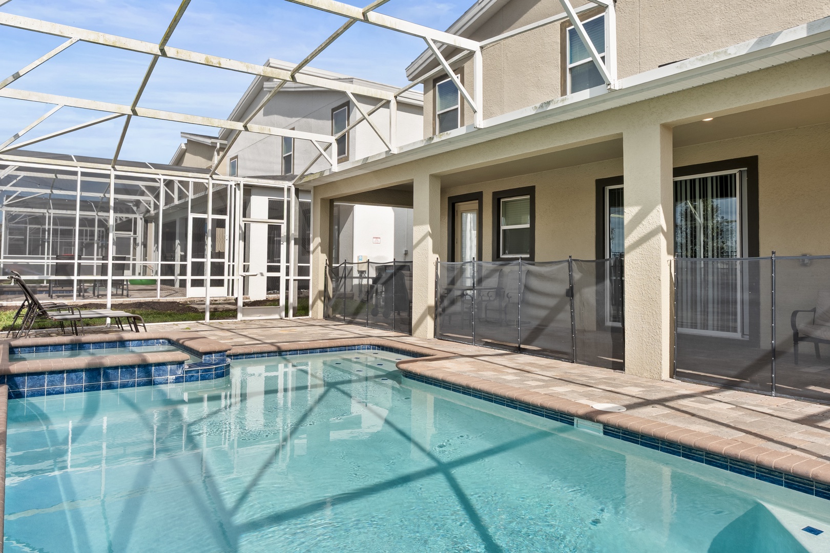 Your private screened pool awaits with crystal-clear waters and comfortable poolside seating for endless relaxation.