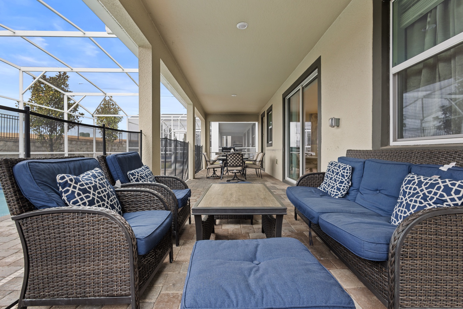 Unwind on your private covered terrace with plush blue seating, perfect for morning coffee or evening relaxation.