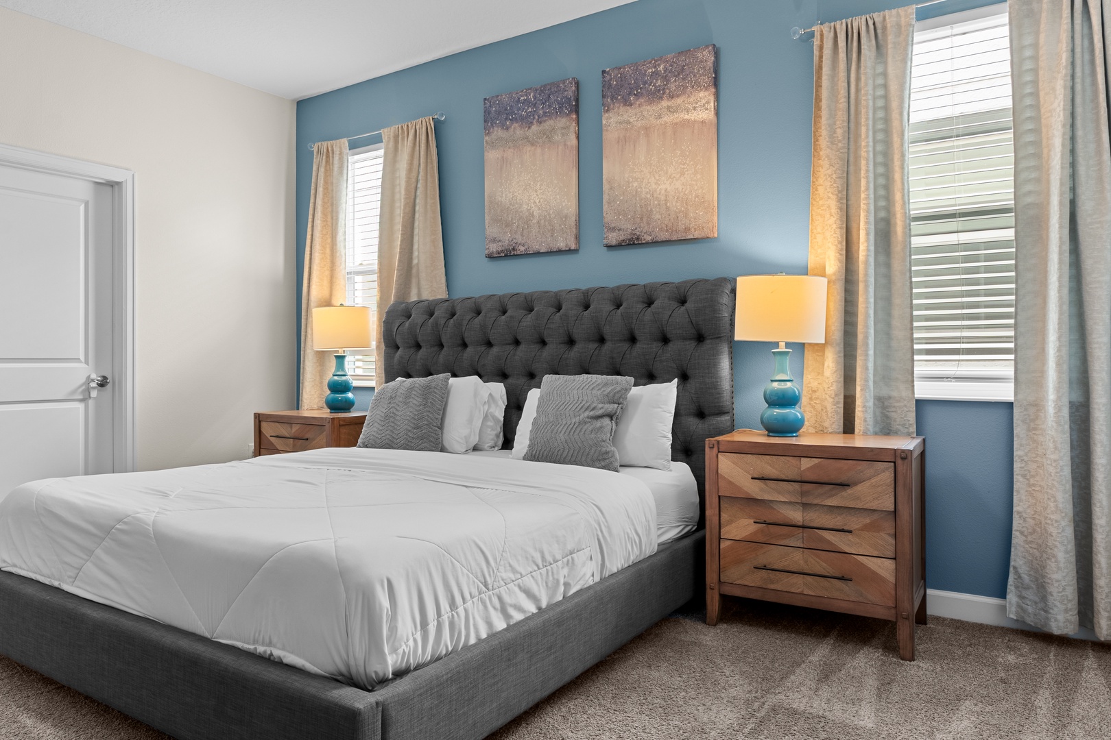 Sink into your plush tufted bed surrounded by calming blue walls and warm lamplight for the perfect restful retreat.