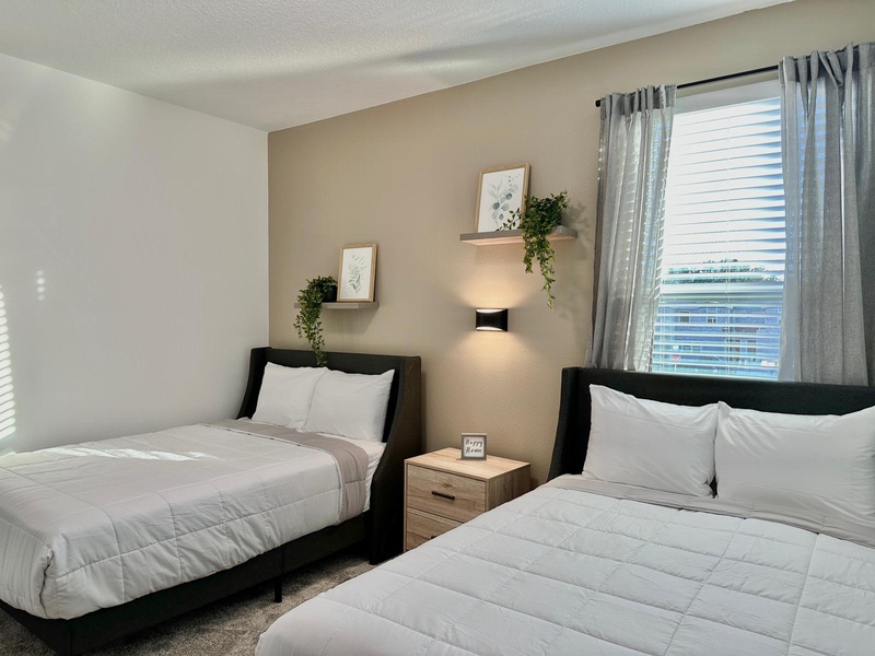 Rest peacefully in your twin bed sanctuary with crisp white linens, modern touches, and natural light streaming through your window.
