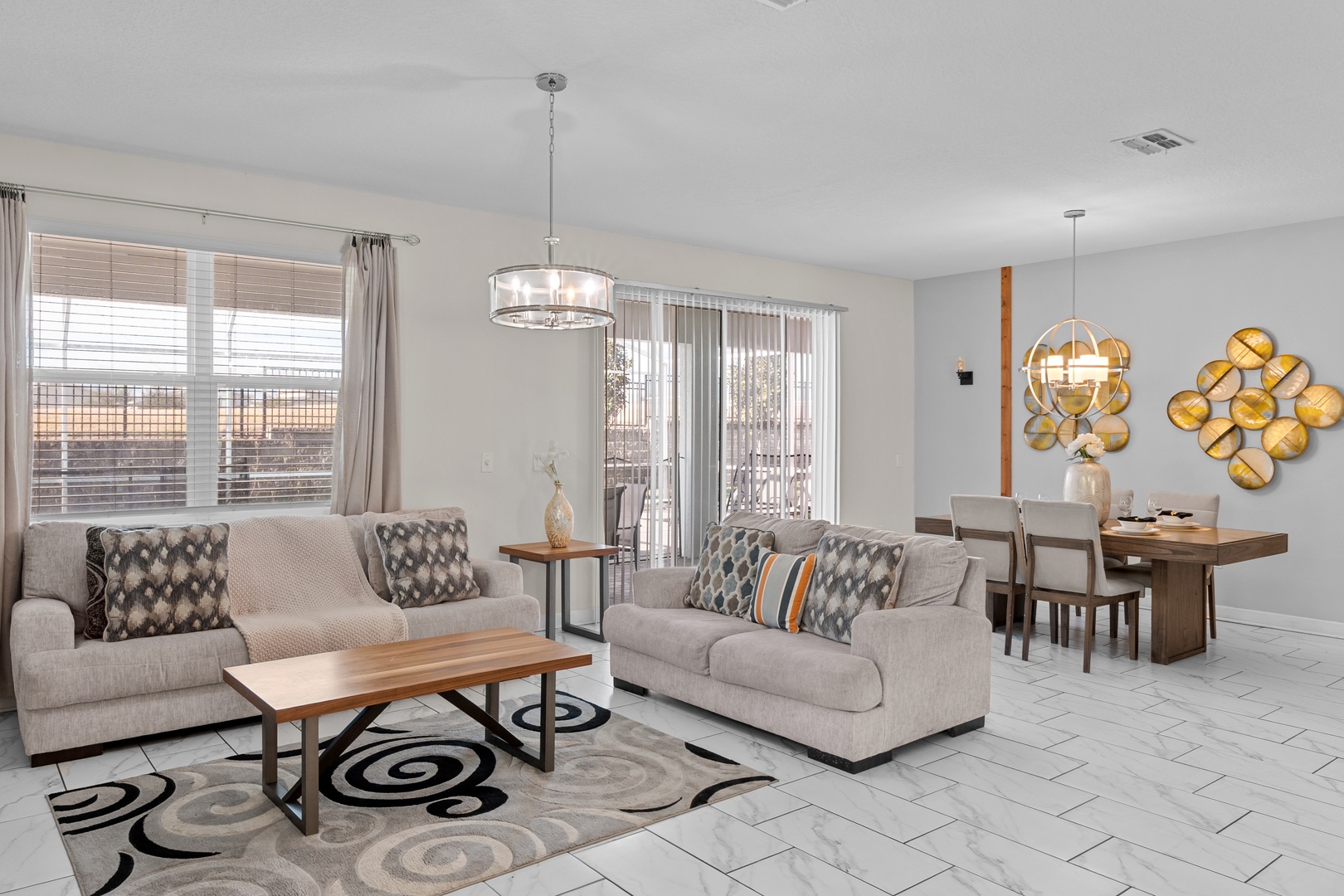 Sink into plush sofas in your bright, modern living space with stylish décor and open dining area perfect for memorable meals.