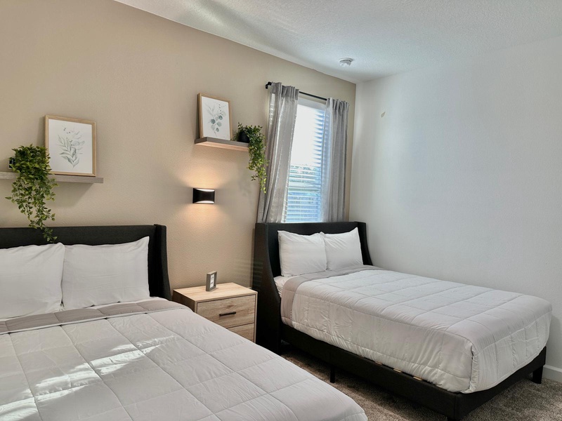 Two comfortable beds await your restful stay, with soft linens and calming decor creating the perfect retreat.