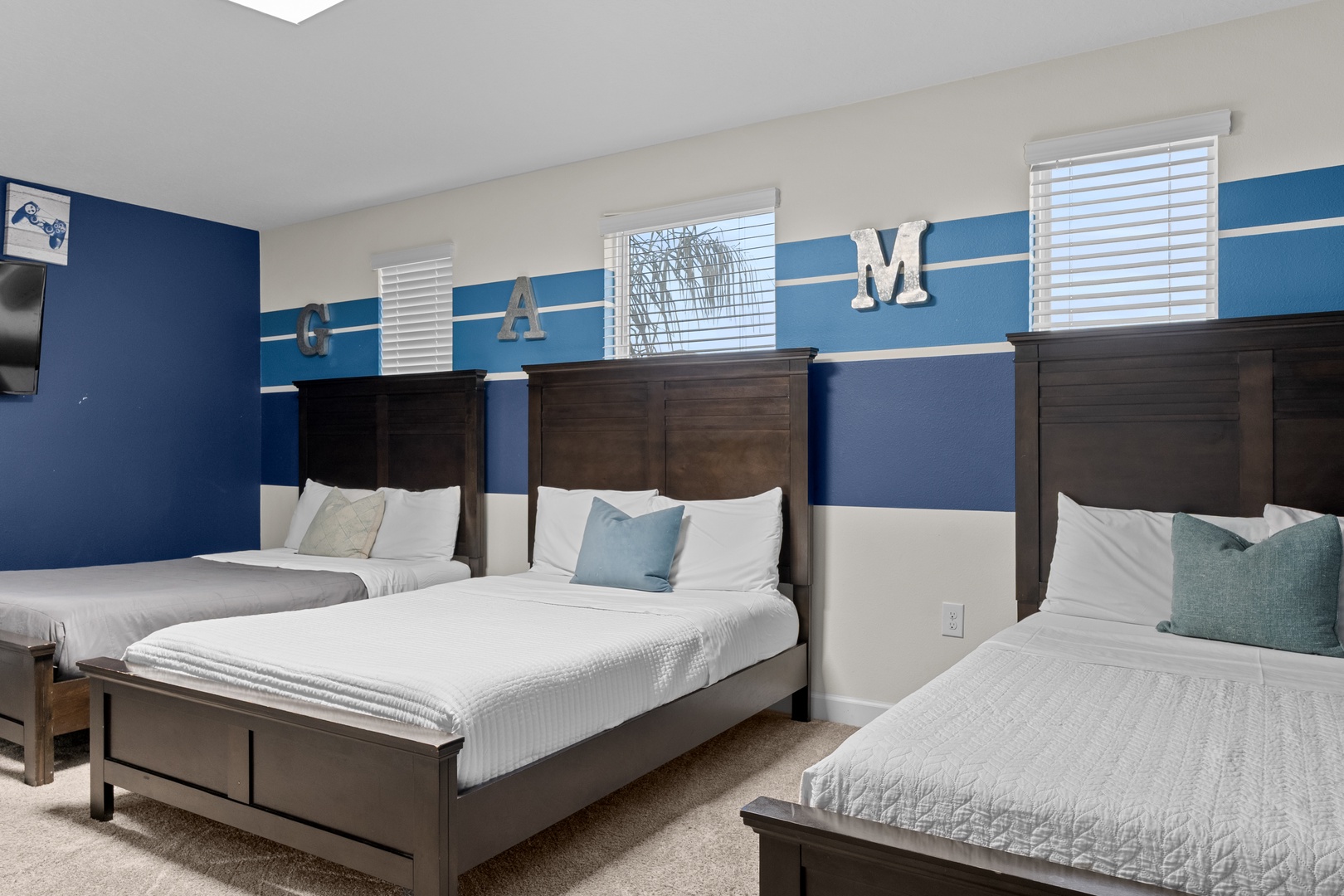 Sleep soundly in your spacious room with three comfortable beds, each topped with soft linens and accent pillows for the perfect night's rest.