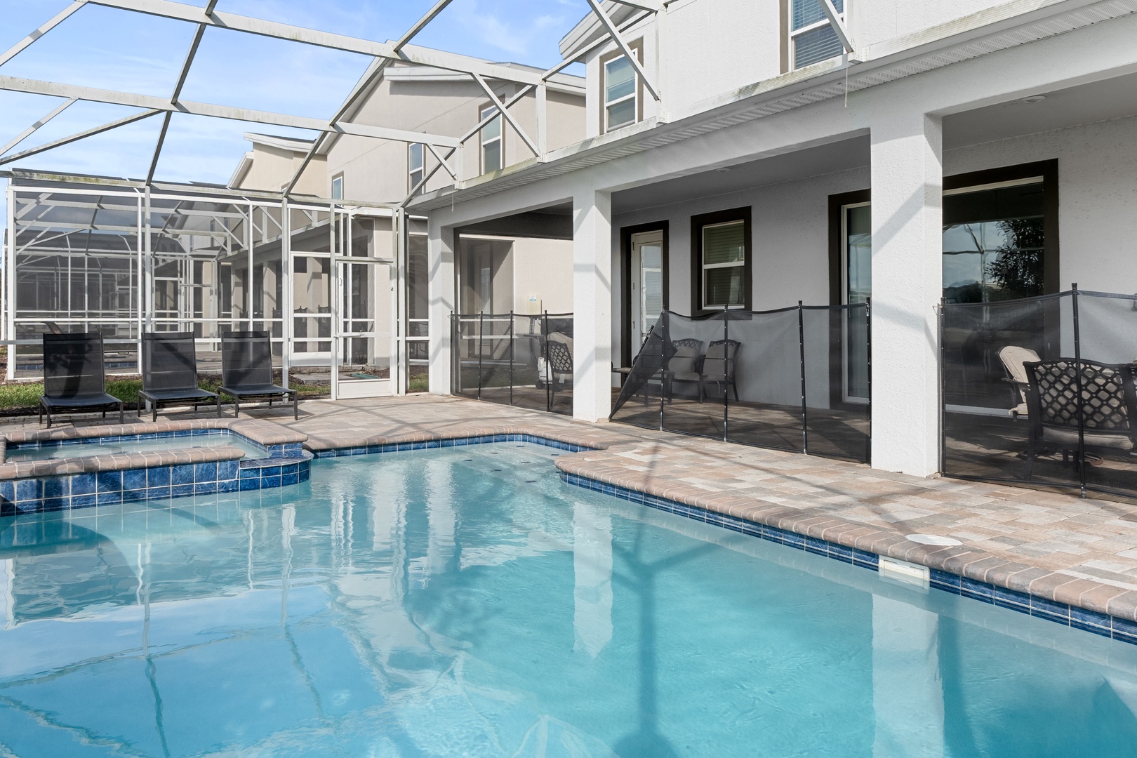 Your private heated pool awaits, perfectly framed by screened lanai and comfortable poolside seating for ultimate relaxation.