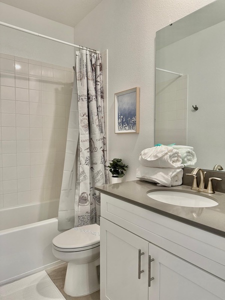 Step into your pristine private bathroom with fresh towels, modern fixtures, and everything you need for a refreshing stay.