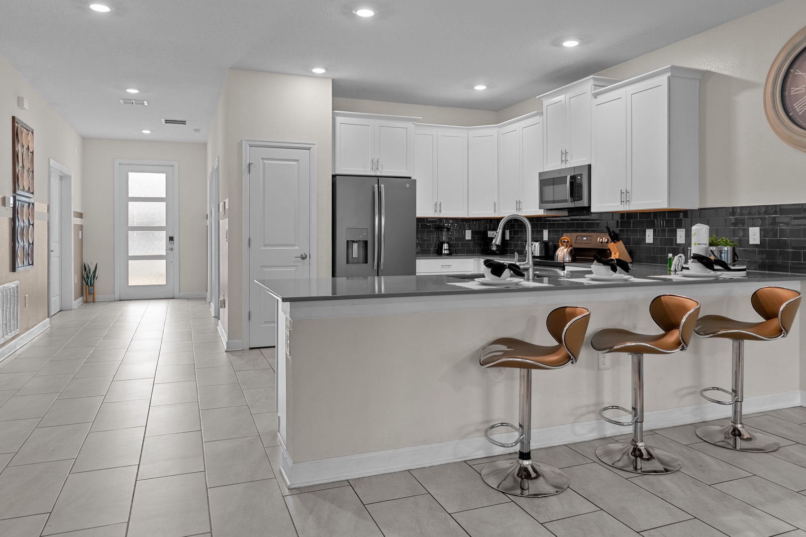 Your fully equipped kitchen features modern appliances, granite counters, and a breakfast bar perfect for casual meals.