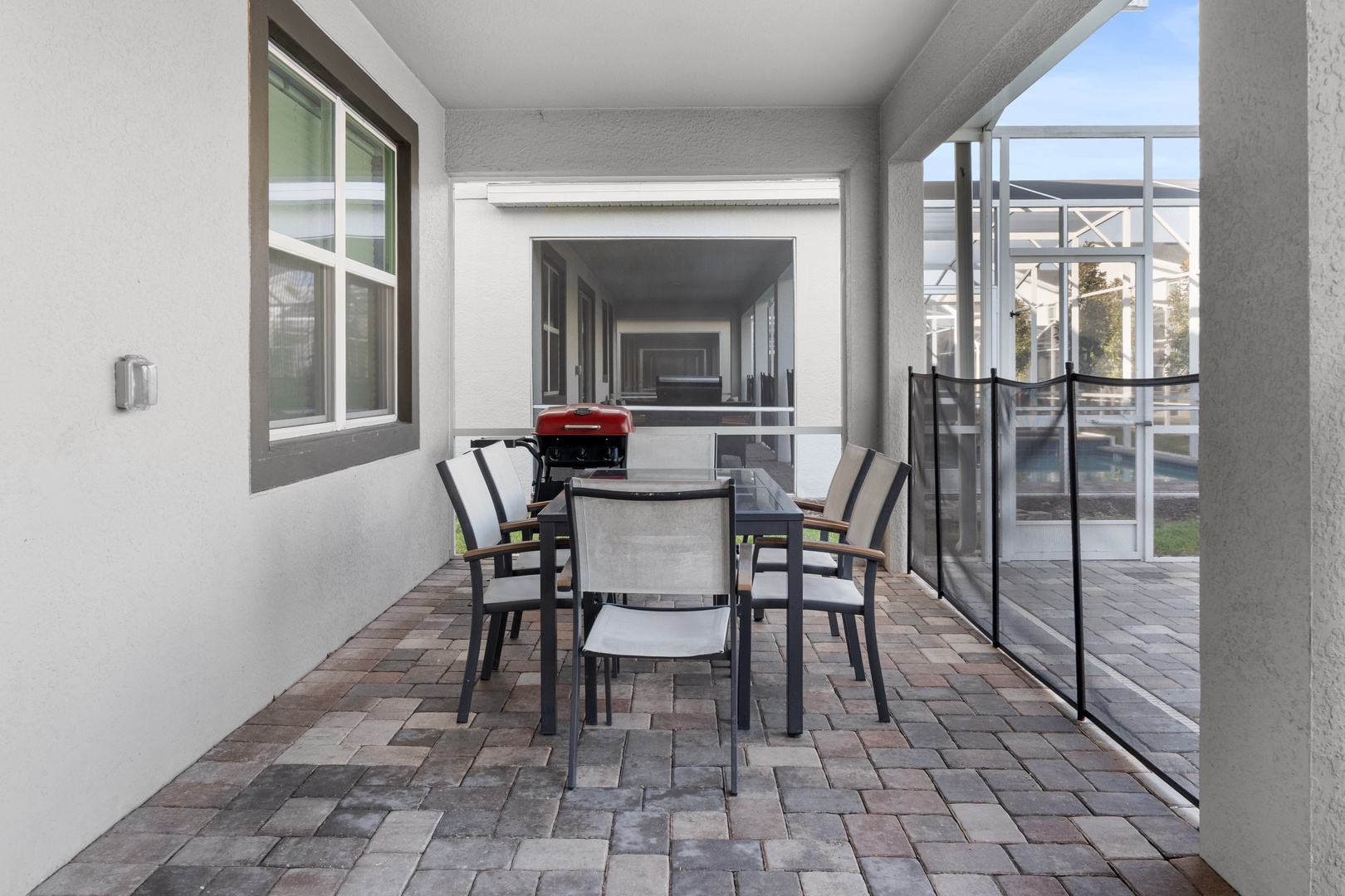 Your private covered patio offers the perfect spot for outdoor dining with a sleek table and comfortable seating for memorable meals.