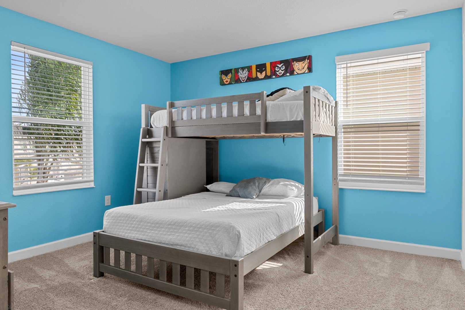 Your kids will love this bright blue bedroom with fun bunk beds and superhero decor that sparks imagination and adventure.