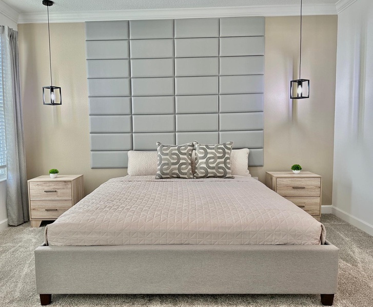 Sink into this serene master bedroom where modern elegance meets comfort. Your peaceful retreat features a striking tufted headboard and ambient lighting.