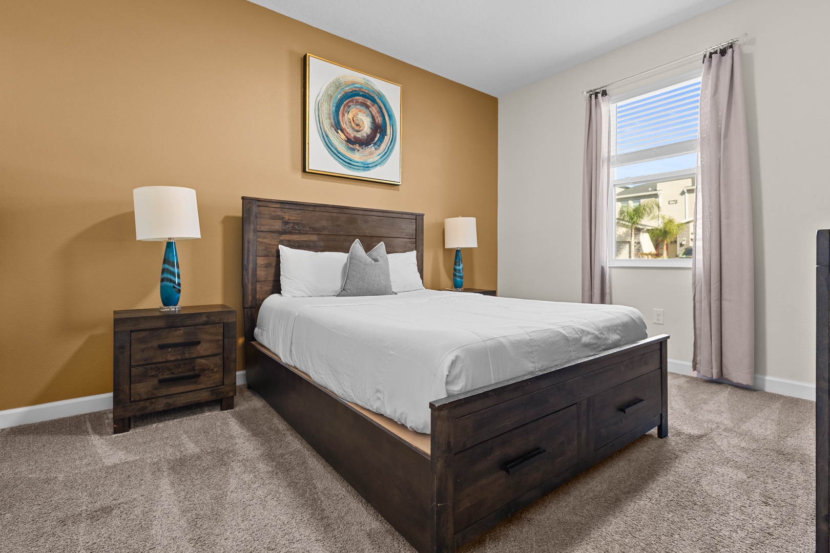 Sink into plush bedding in your serene bedroom, where warm accent walls and coastal artwork create the perfect retreat for peaceful nights.