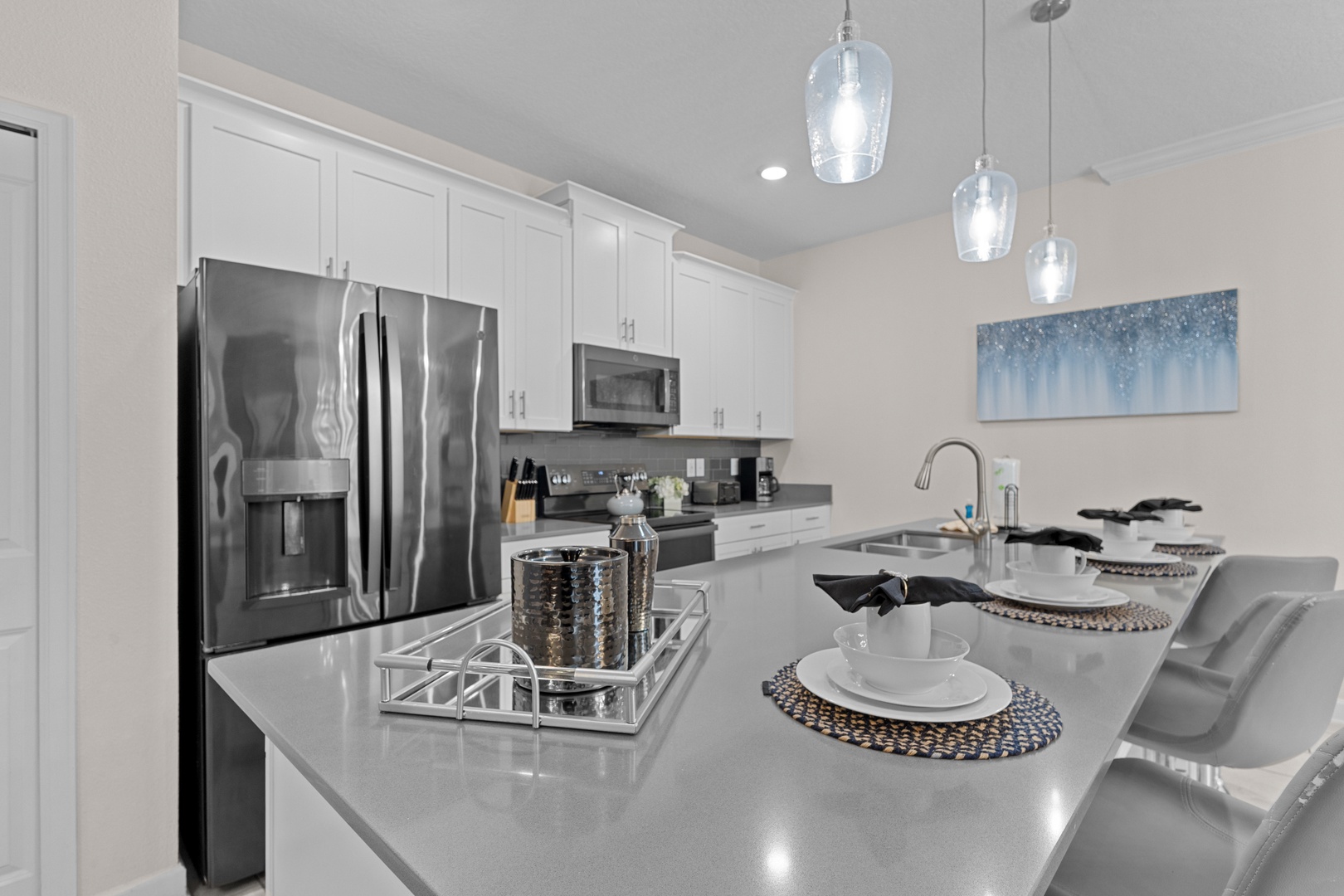 Your modern kitchen features sleek quartz countertops, stainless steel appliances, and elegant pendant lighting—perfect for preparing memorable meals.