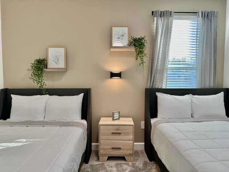 Your comfortable twin bedroom features crisp white linens and modern touches, perfect for a restful night's sleep after exploring the city.