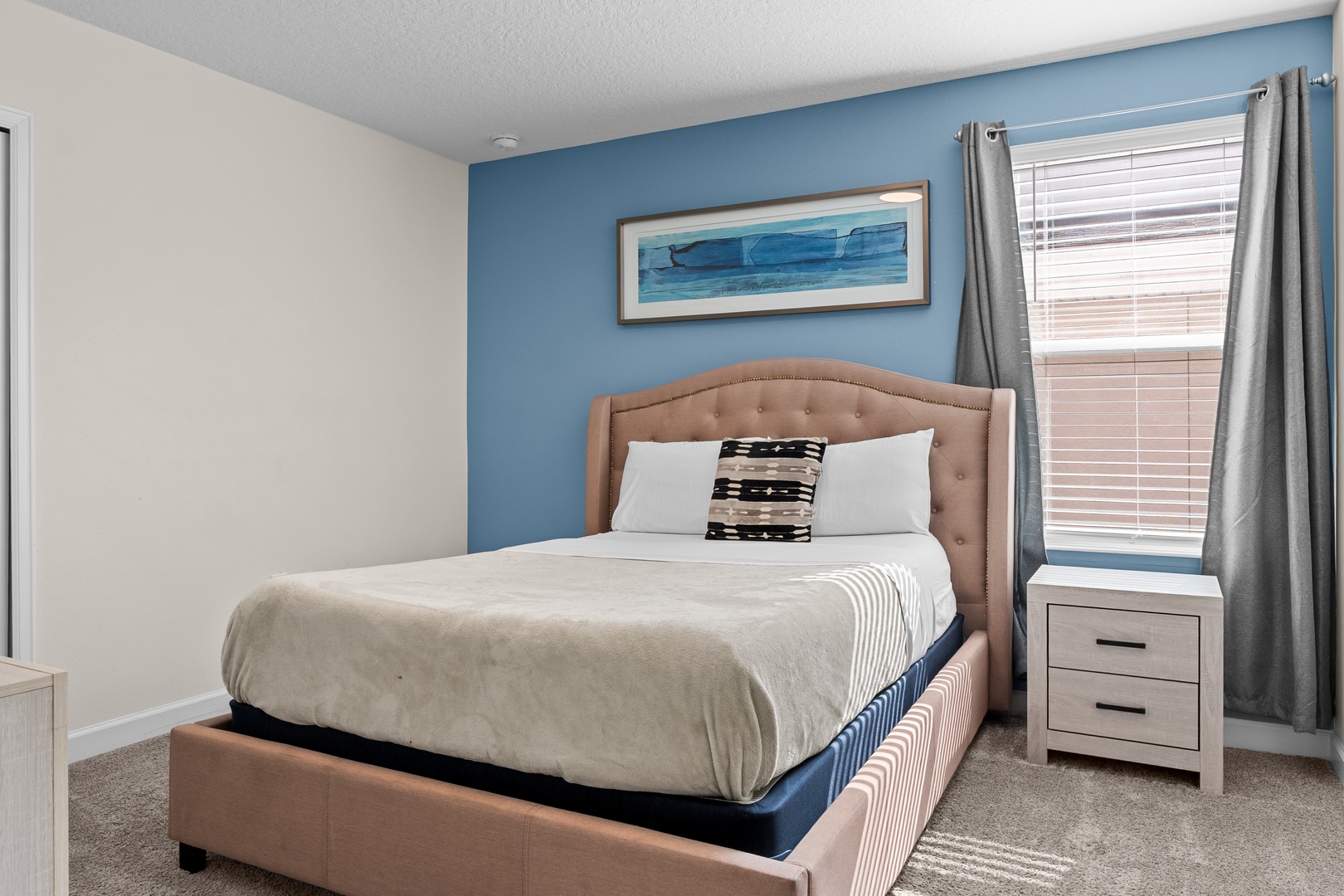 Drift off to peaceful dreams in your cozy bedroom featuring coastal blues and soft linens that invite restful nights.