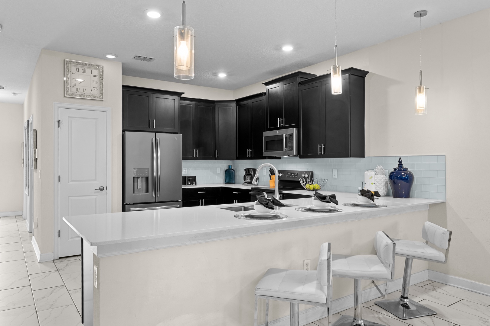 Your sleek kitchen features premium appliances, quartz counters, and modern pendant lighting—perfect for preparing memorable meals during your stay.