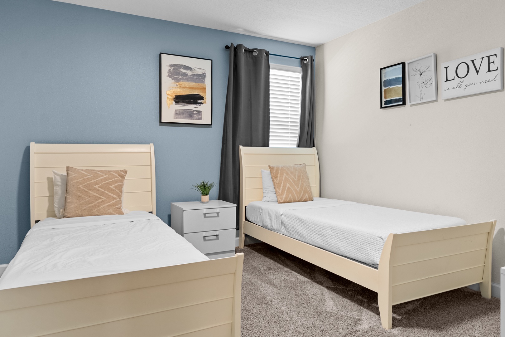 Two cozy twin beds await in your serene bedroom, featuring soft linens and thoughtful touches for a peaceful night's rest.