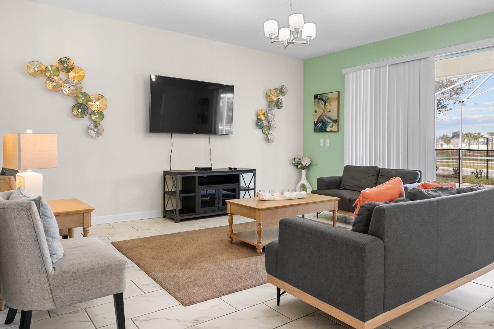 Unwind in your stylish living room with plush seating, modern entertainment center, and cheerful green accents that create the perfect atmosphere for relaxation.