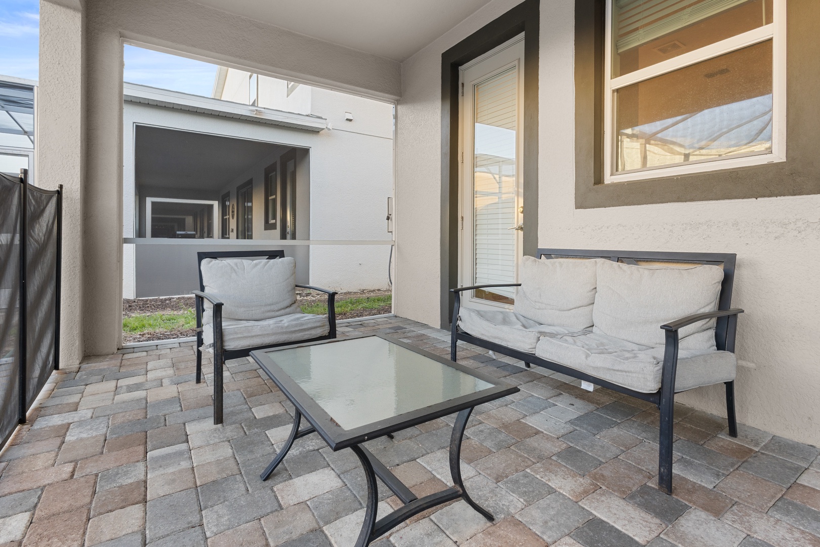 Step onto your private covered patio with comfortable seating, perfect for morning coffee or evening relaxation.