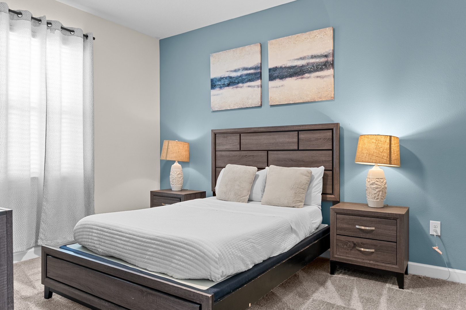 Drift into peaceful sleep in your calming bedroom featuring soft blue walls, crisp linens, and warm bedside lighting.
