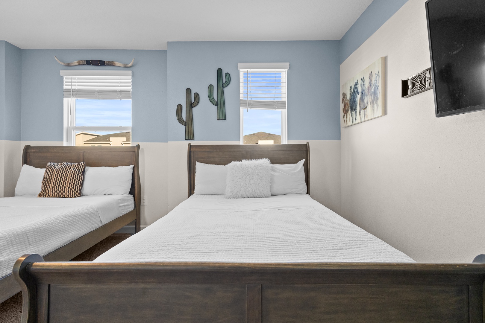 Rest peacefully in your southwestern-themed twin bedroom, complete with cozy beds and desert-inspired decor that creates a serene retreat.