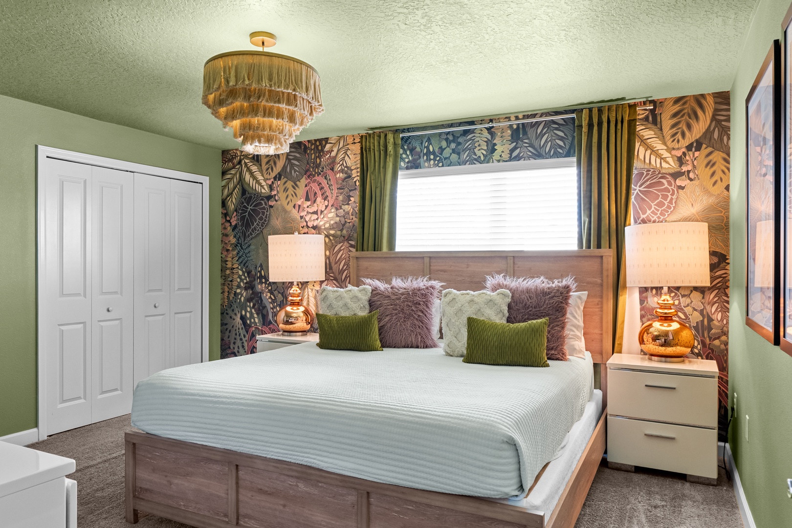 Your tropical paradise awaits in this stunning bedroom with bold botanical wallpaper, luxurious textures, and warm lighting creating the perfect retreat.