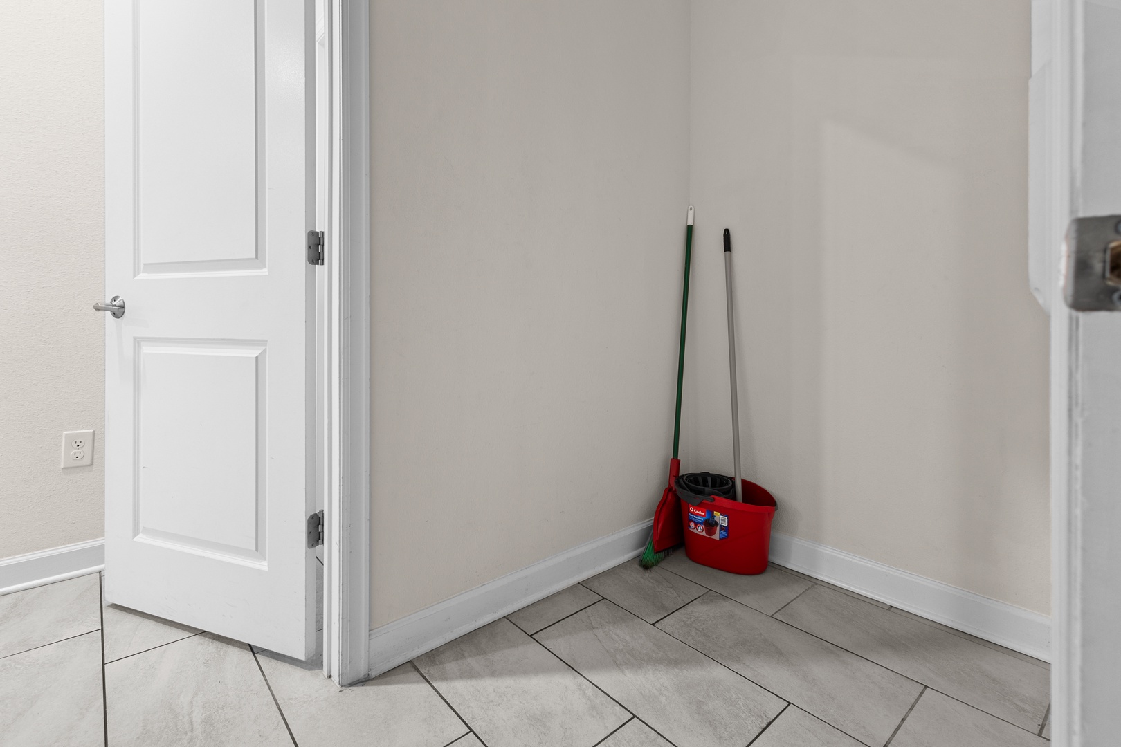Your cleaning supplies are conveniently stored in this tidy utility closet, keeping everything organized and accessible.