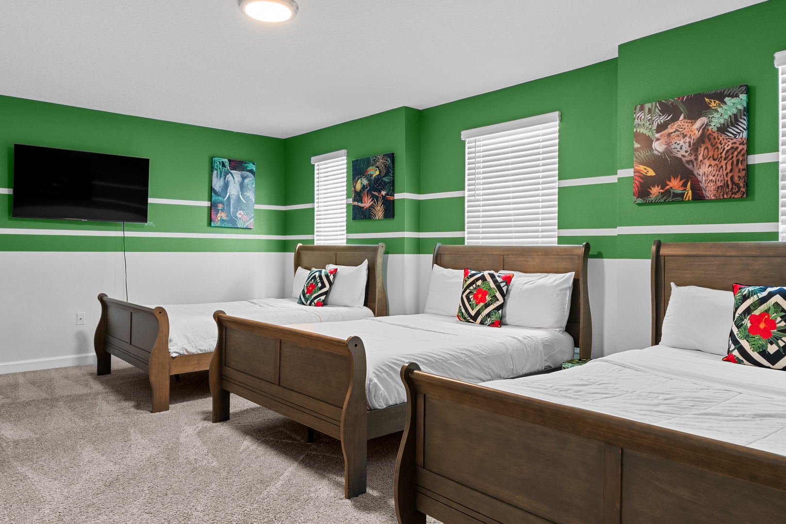 Unwind in your vibrant jungle-themed bedroom with three comfortable beds and your own wall-mounted TV for movie nights.