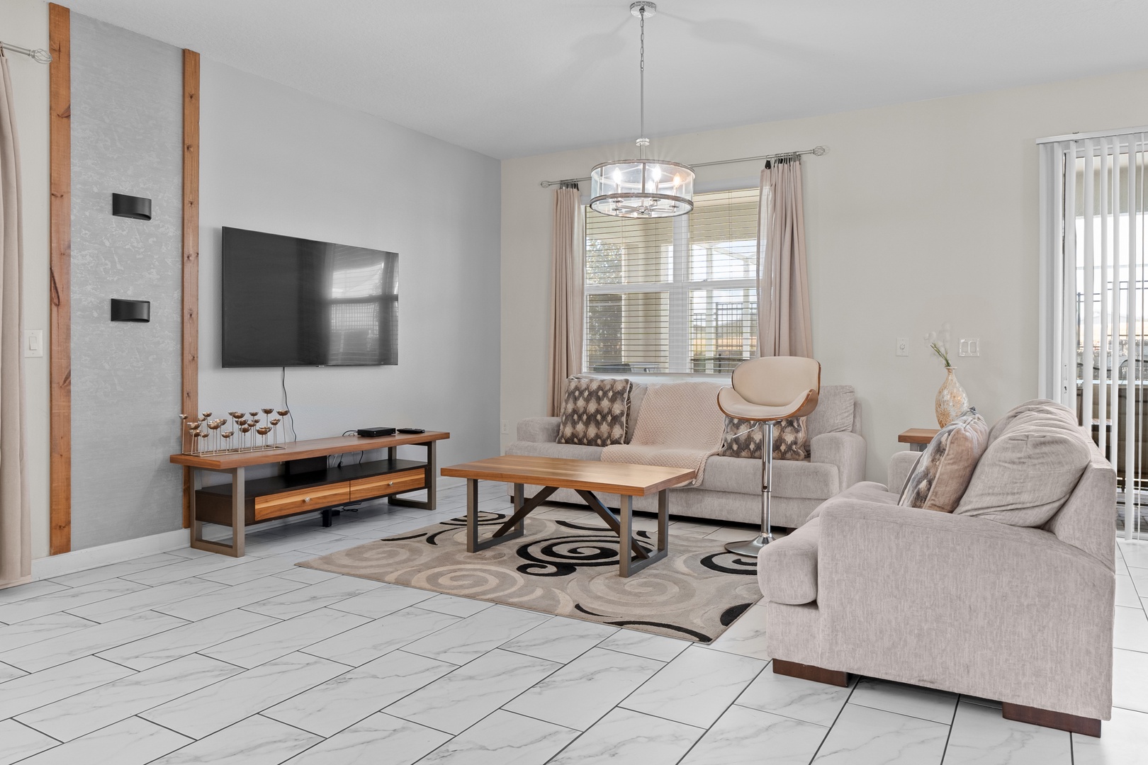 Relax in your spacious living room with modern comfort and warm wood accents creating the perfect space to unwind.