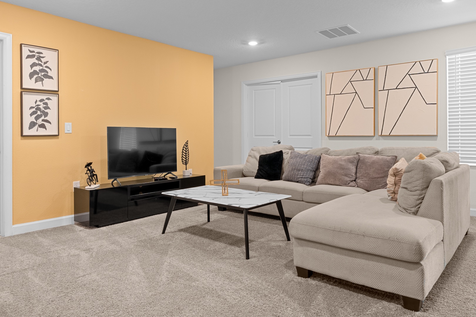 Sink into the plush sectional sofa and enjoy your favorite shows on the large TV in this stylish living space.