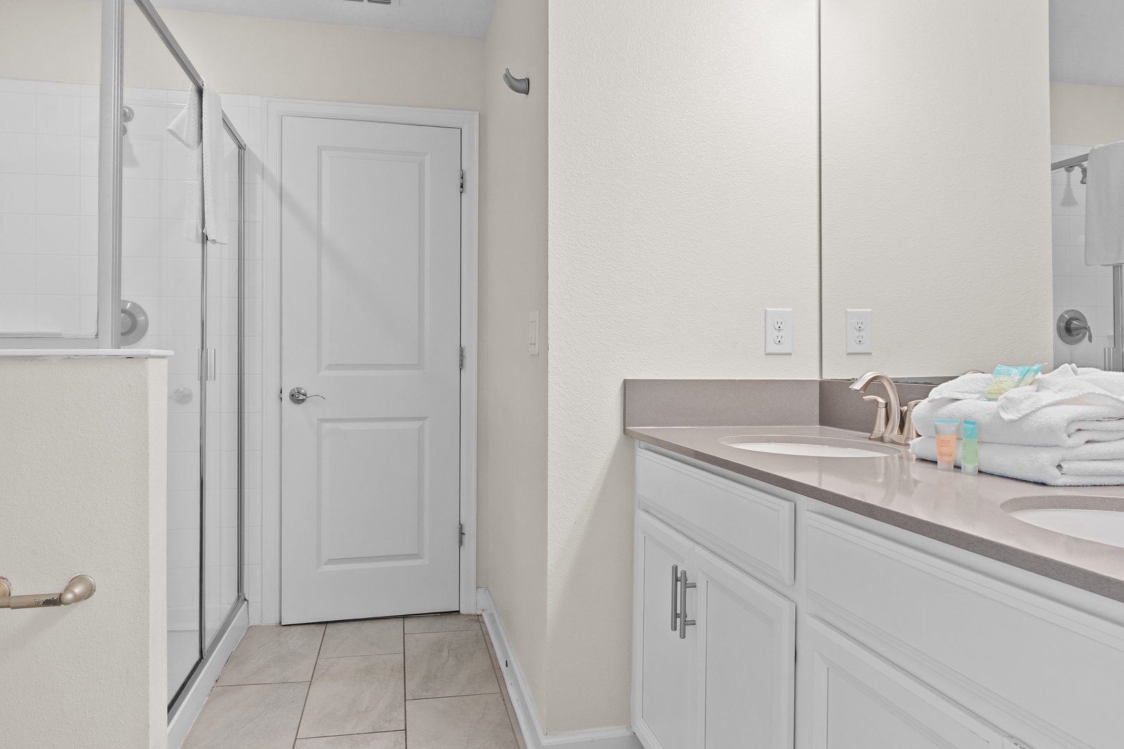Your pristine ensuite features elegant marble countertops, modern fixtures, and a spacious glass shower for ultimate comfort.