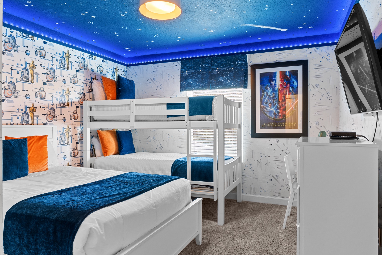 Your kids will feel like galactic heroes in this magical Star Wars themed bedroom with cozy bunk beds and starry ceiling.