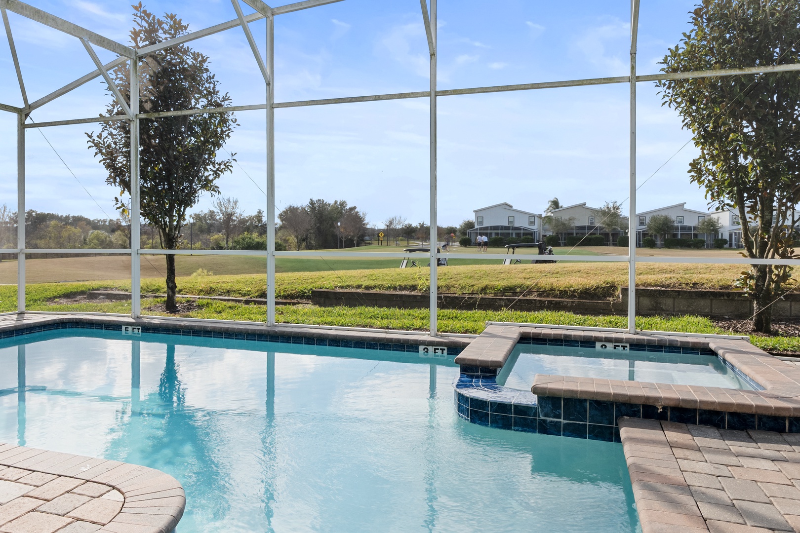 Dive into your private pool sanctuary, where sparkling waters and a relaxing spa await beneath a protective screen enclosure.