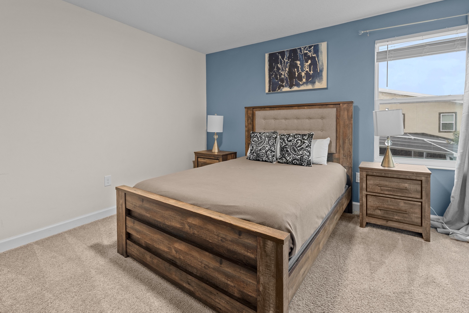 Sink into your comfortable bed surrounded by warm wood furnishings and calming blue accents for the perfect night's rest.