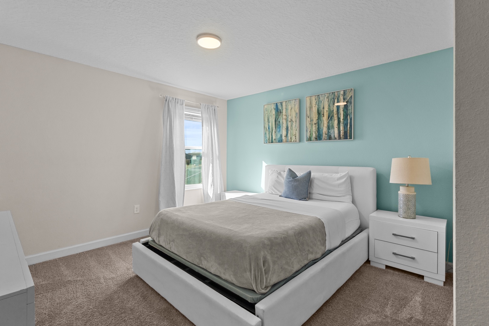 Sink into your crisp white bed surrounded by soothing coastal colors and natural light streaming through your private window.