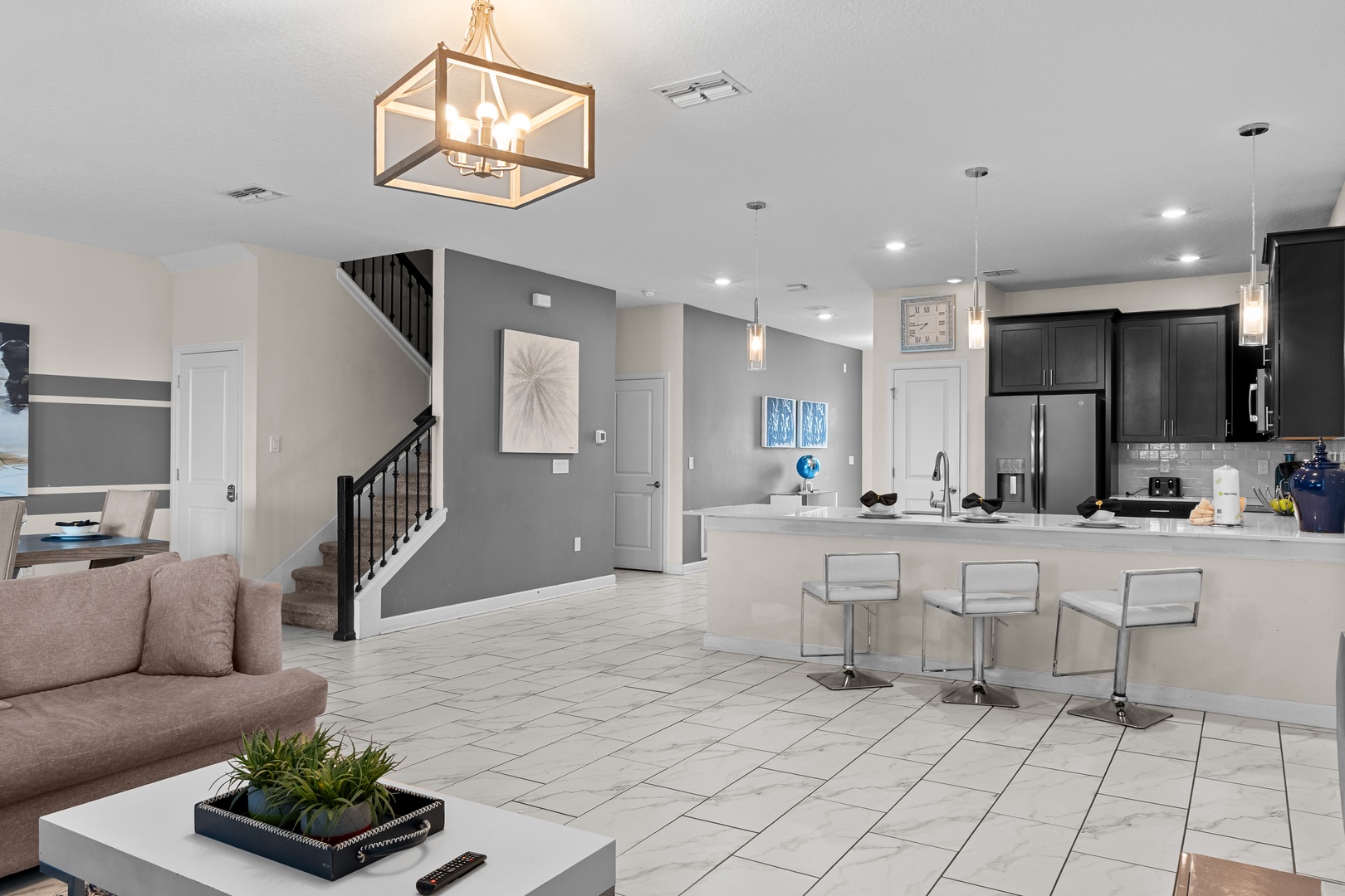 Your modern open-concept space blends kitchen and living seamlessly with sleek countertops, contemporary fixtures, and warm lighting.