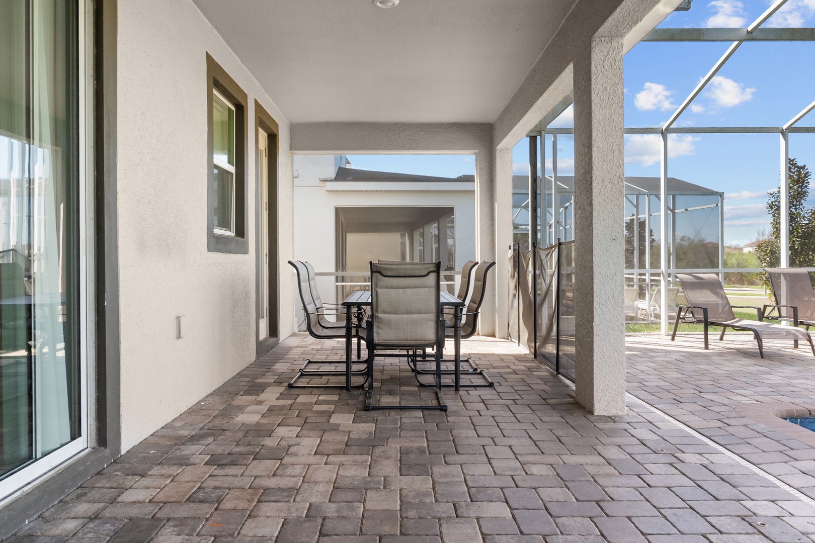 Your covered outdoor dining space features elegant patio furniture where you can enjoy meals while staying cool in the shade.