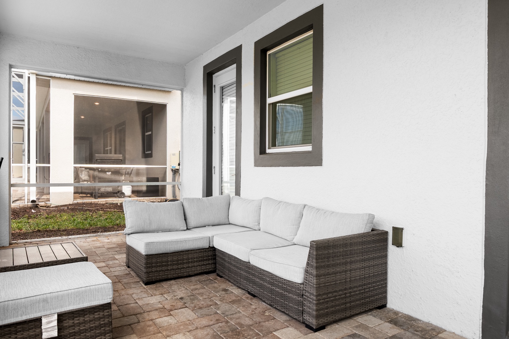 Relax on your private covered patio with comfortable sectional seating and views of the interior courtyard.