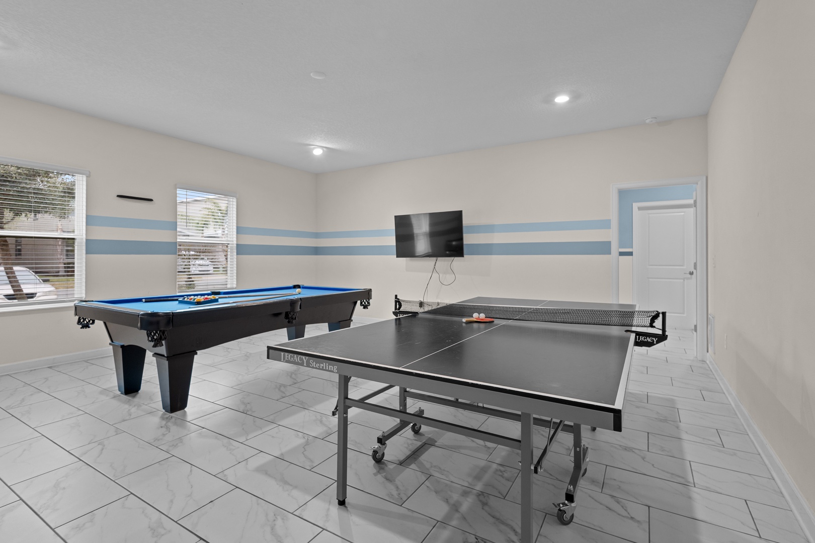 Challenge friends to pool or ping pong in your dedicated game room with sleek marble floors and wall-mounted TV entertainment.