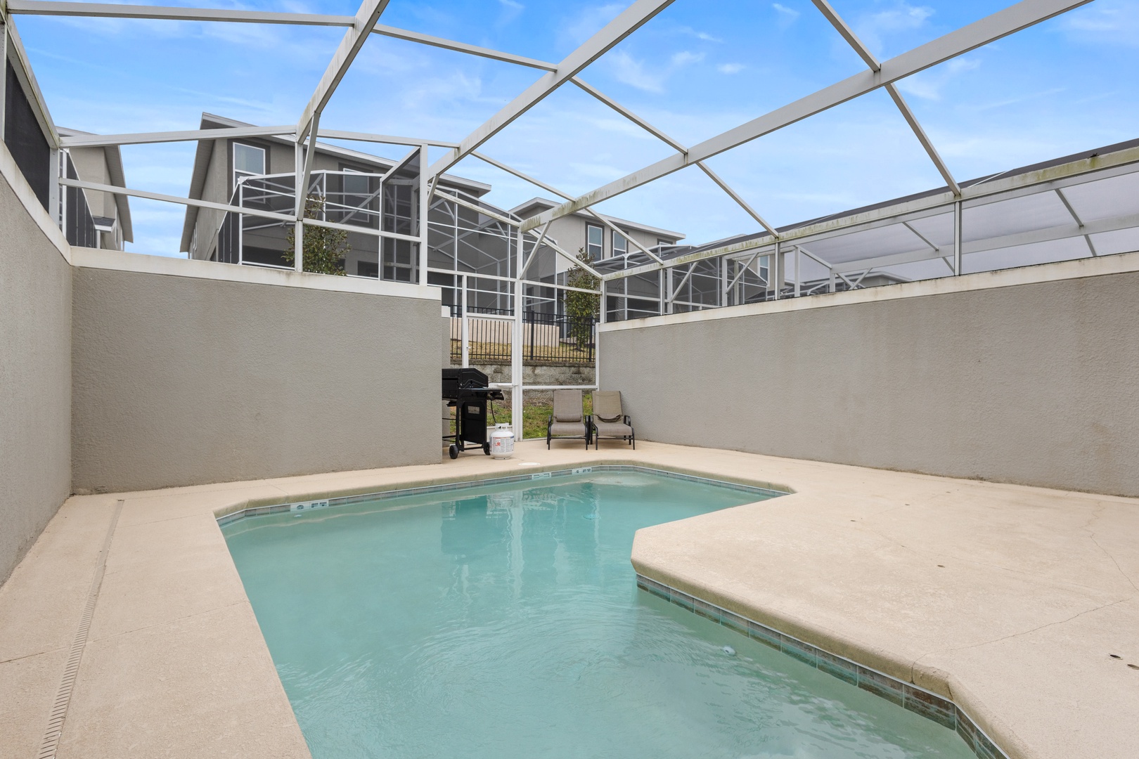Dive into your private pool paradise, where Florida sunshine filters through the screened enclosure while you unwind poolside.